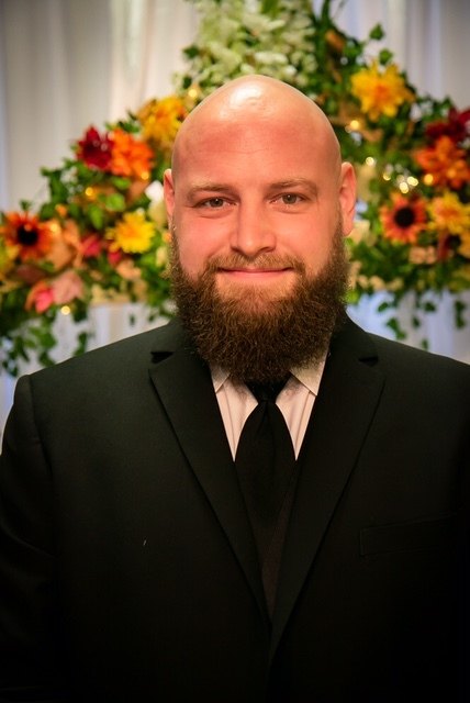 A bald man in a suit and tie.