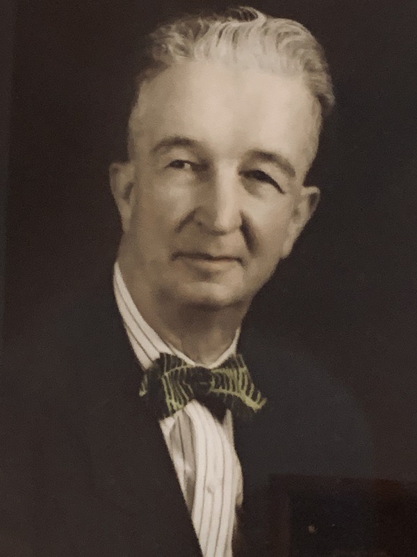 An old photo of a man in a suit and tie.