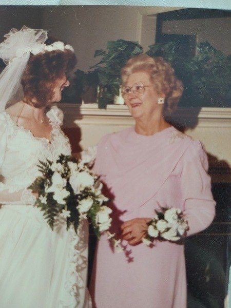 An old photo of a bride and her mother.