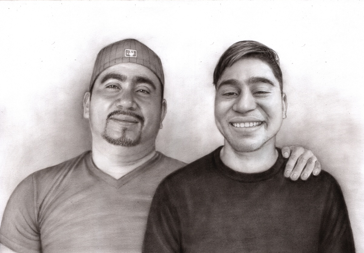 Premium charcoal portrait of two men smiling.