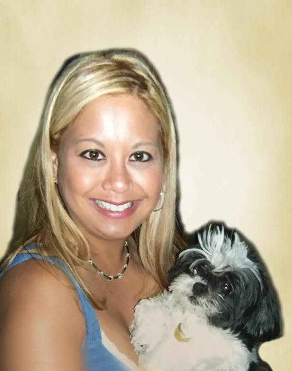 A woman holding a small dog on a beige background.