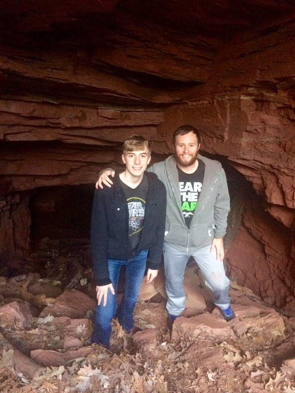 two men standing in a cave