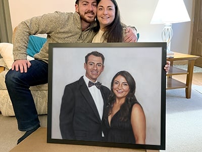 A couple's photo turned into a painting featuring them in the the painting, the couple inside a house on the couch