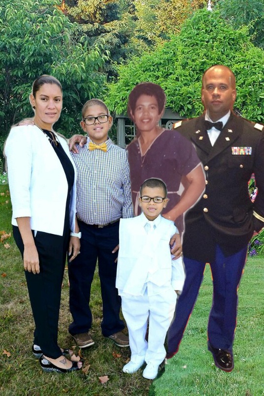 A family posing for a photo in front of a military cutout.