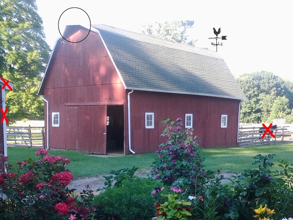 A red barn with arrows pointing to it.