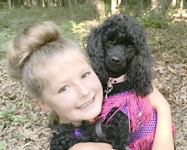 a child holding a dog