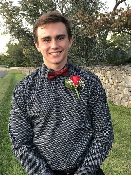 A young man wearing a bow tie and shirt.