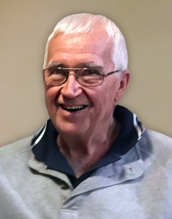 An older man wearing glasses and a gray shirt.