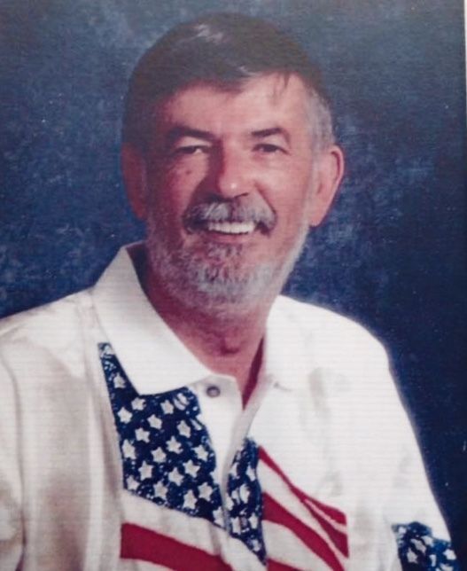 A photo of a man wearing an american flag shirt.