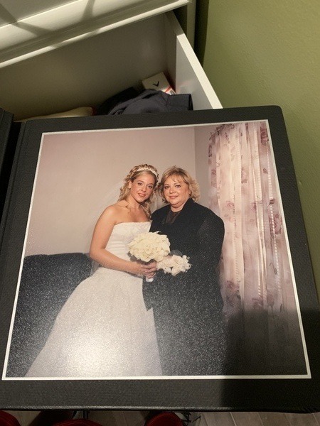 A photo of a bride and her mother in a photo album.