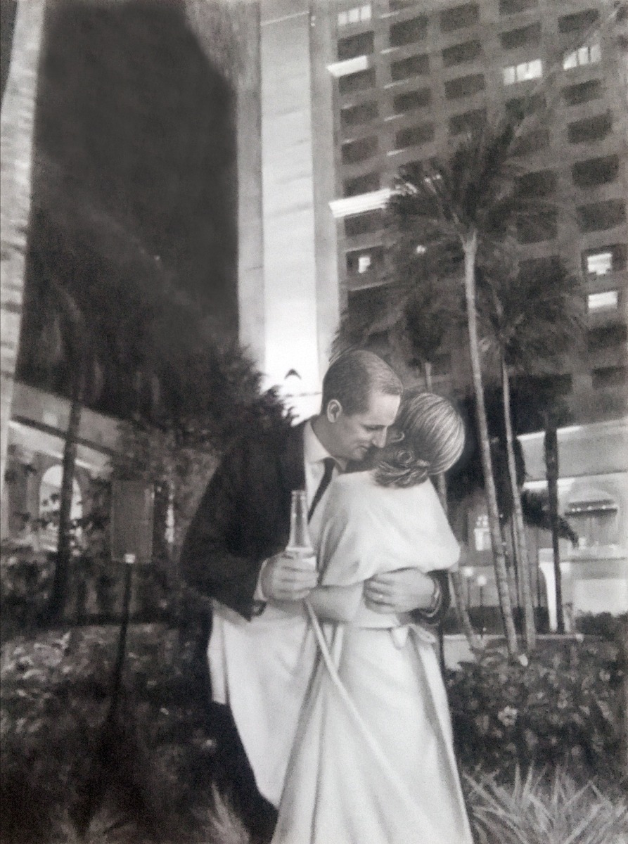 A black and white photo of a couple kissing in front of a building, with a charcoal dark style.
