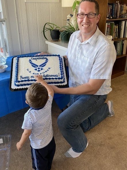 a person and child holding a cake