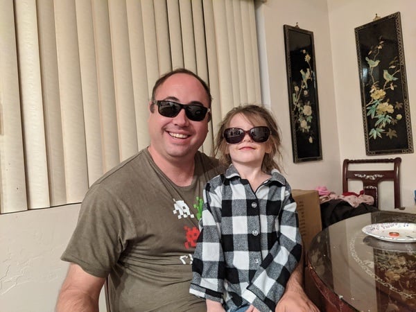A man and a little girl wearing sunglasses.