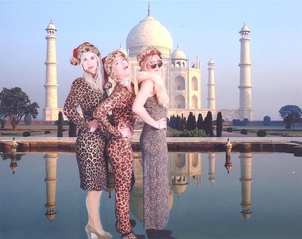 a group of women in leopard dresses in front of a building