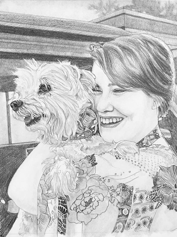 A pencil sketch of a woman holding a dog.